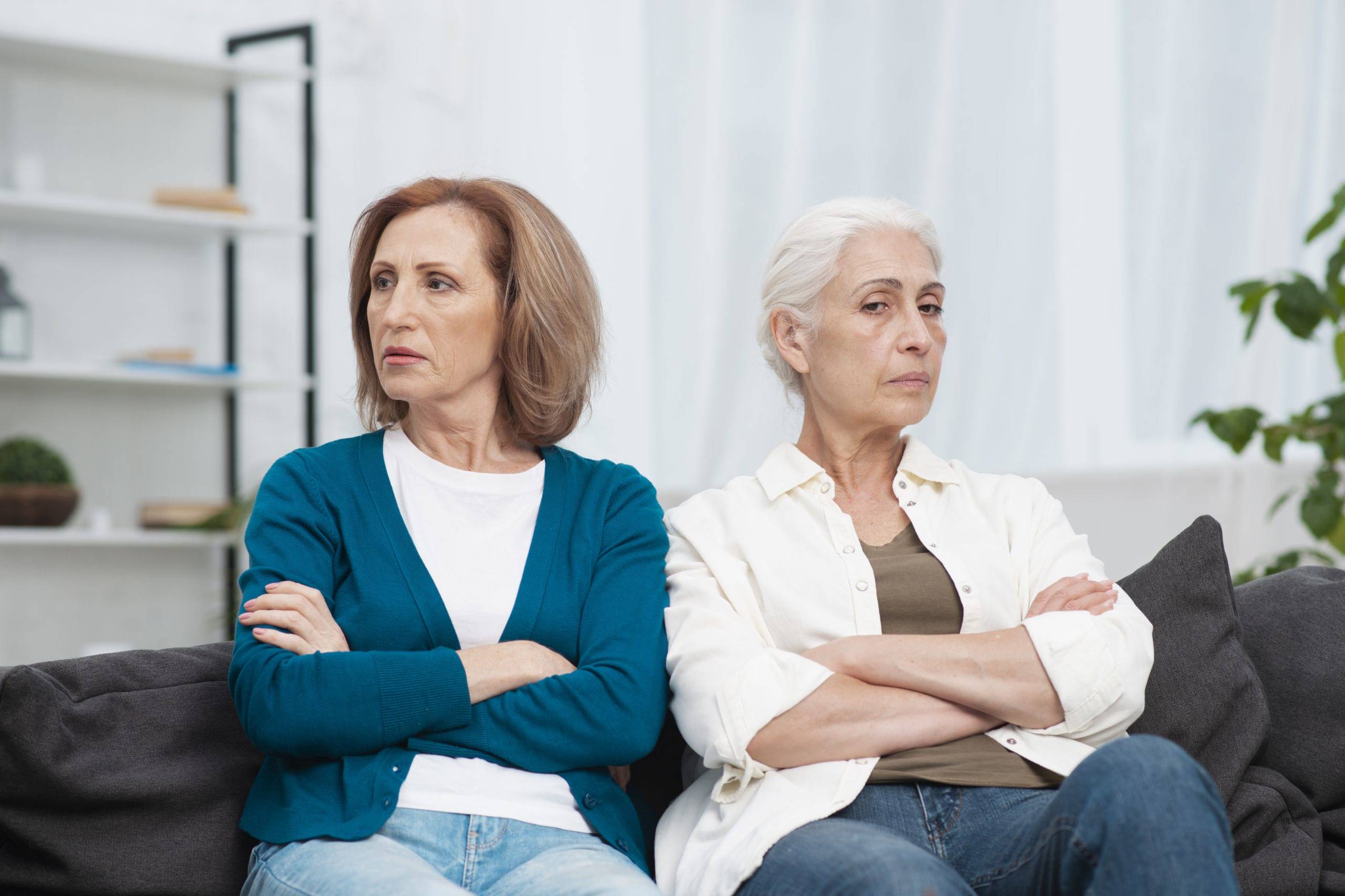 portrait-mother-and-daughter-upset-with-each-other-while-daughter-thinks-of-what-to-do-when-elderly=parents-refuse-care